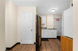 Located at the back Sink, refrigerator, microwave