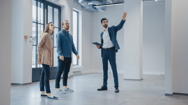 Two business owners being shown a commercial space